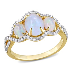 1 1/4 ct tgw oval cut ethiopian blue opal and 1/3 ct tw diamond halo 3-stone ring in 10k yellow gold