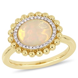 2 ct tgw oval-cut yellow ethiopian opal and 1/10 ct tw diamond halo ring in 14k yellow gold