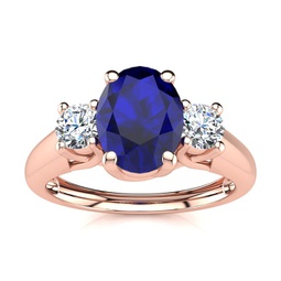 1 1/5 carat oval shape sapphire and two diamond ring in 14 karat rose gold