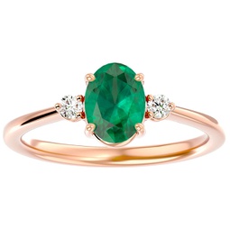 1 1/4 carat oval shape emerald and two diamond ring in 14 karat rose gold