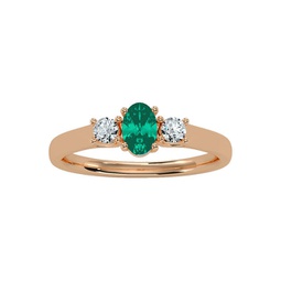 1/2 carat oval shape emerald and two diamond ring in 14 karat rose gold