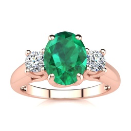 1 1/3 carat oval shape emerald and two diamond ring in 14 karat rose gold