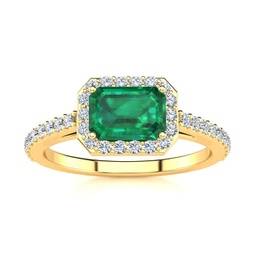 1 1/4 carat emerald and halo diamond ring in 14 karat yellow gold